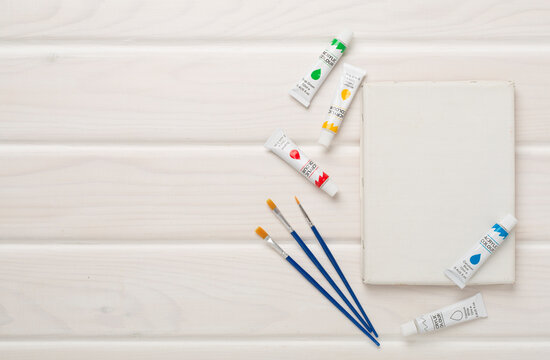 Painting tools on wooden background, top, view