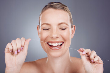 Floss, teeth and smile of woman in studio for beauty, healthy dental hygiene and background. Happy...