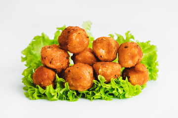 Breaded chicken nuggets.Breaded Chicken Inner Fillet with green lettuce leaves on a White Background.Chicken Breaded Raw Meat,Fillet.Fast homemade food at home. Chicken breaded schnitzels.Fast cooking