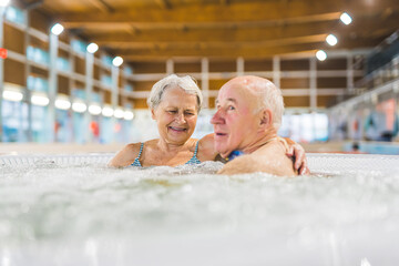 happy caucasian grandparents relaxing in a bath and actively spending their time. High quality photo