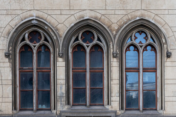 Old windows on the decorative facade of a building of the old town hall