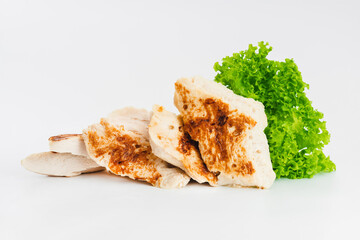 Chicken fillets fried until half cooked, semi-finished product with fresh herbs on a white background. Fast cooking.Fast homemade food.Fast food. Quick cooking at home. Copy space.