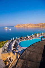 Blue Pool near the building on a background of blue sky and sea in Greece.