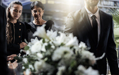 Funeral, coffin and family or friends at death, mourning and church burial event sad together....