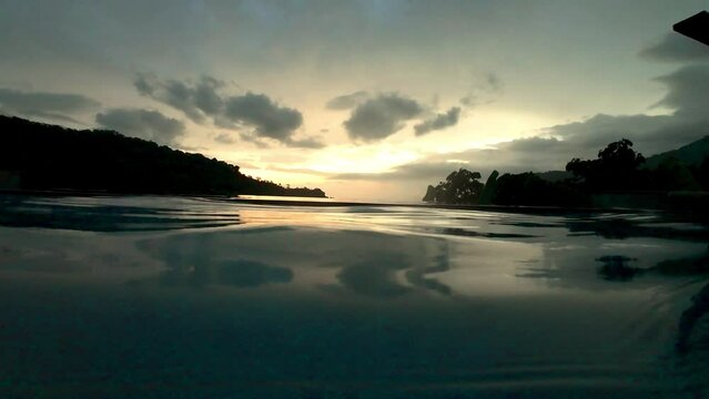 View of the sunset over the mountain from the swimming pool