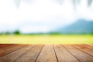 Luxury of old wooden floor beside natural green rice field mountain and blurred sky with the cloud...