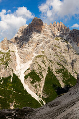 Fototapeta na wymiar Hiking through Dolomite Mountains is surreal experience, surrounded by jagged peaks and serene landscapes.