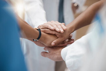 Hands, collaboration and healthcare with a medicine team in a huddle or circle in the hospital for insurance or medical. Teamwork, motivation and solidarity with a doctor and nurse group in a clinic
