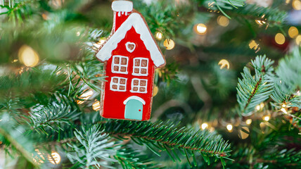 Christmas toys.red decorative house and shining bokeh garlands on a Christmas tree...