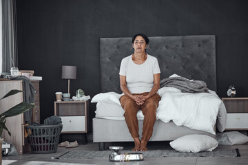Tired, morning and a woman in the bedroom with chaos, messy and thinking. Idea, sad and a senior...