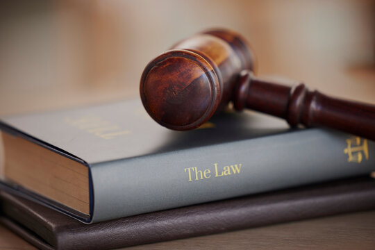 Background, gavel and law books on table of attorney, judge and justice for courtroom. Closeup of legal hammer, notebook and desk of lawyer in constitution of truth, fair information and human rights - Powered by Adobe