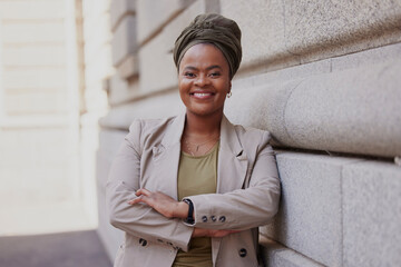 Lawyer, happy and black woman is confident in city with vision or empowerment in career. Smile, portrait and african female attorney with crossed arms at job as advocate outside courtroom or agency.