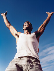 Cheerful African Amerian Man Enjoying Victory Against Blue Sky; AI Generated - 671914915