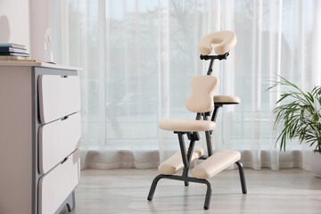 Modern massage chair in clinic, space for text. Medical equipment