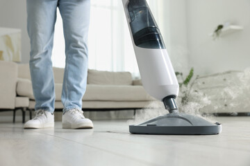 Man cleaning floor with steam mop at home, closeup - obrazy, fototapety, plakaty
