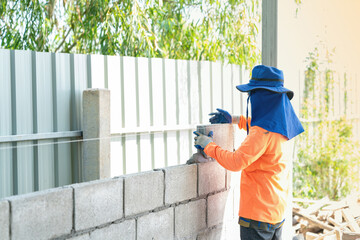 Mansonry install concrete brick for wall of godown.