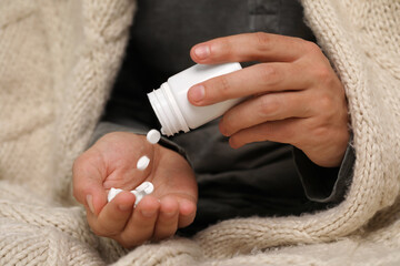 Man pouring antidepressants from bottle, closeup view