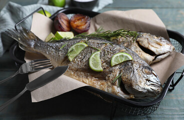 Delicious baked fish served on wooden rustic table, closeup. Seafood
