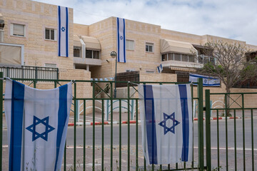 Beer Sheba, Israel -08 may 2022:  Long Banners like Flags of state Israel on the occasion of Independence day in israel. Typical Israeli architecture. Israeli Star of David official flags. Editorial