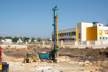 machine mechanism diligently excavates the ground at a construction site to prepare for the installation of concrete structures