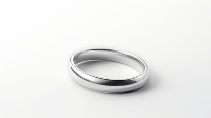 Silver wedding band on white background The ring is a plain, polished band that reflects light. The ring is slightly tilted to the right, creating a dynamic angle. The white background is clean and