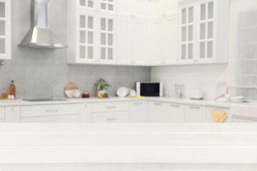 Fototapeta na wymiar Empty white wooden table in beautiful kitchen. Space for design