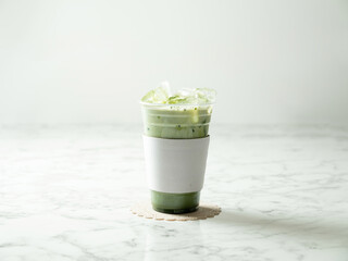 Iced green tea latte in a take-out cup