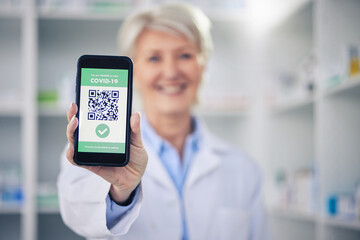 Woman, pharmacist and phone with QR code scan for covid certification or verification at pharmacy....