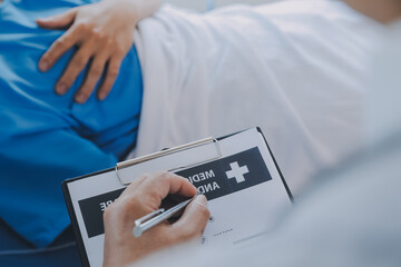 Injured patient showing doctor broken wrist and arm with bandage in hospital office or emergency room. Sprain, stress fracture or repetitive strain injury in hand. Nurse helping customer. First aid.