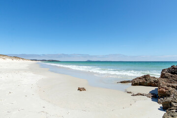 Puheke Beach with Crystal Clear Waters and White Sandy Shores with Coastal Rocks of Karikari Peninsula, Northland, New Zealand