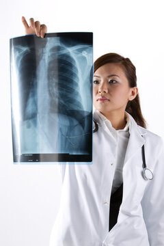 Portrait of a Female Doctor looking at an X-Ray.