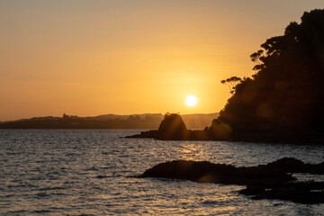 Golden Twilight: Blurred Sunset Background of Russell coastline and bots, Bay of Islands, New Zealand