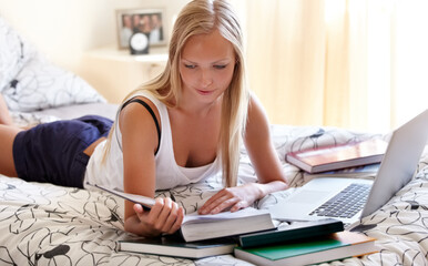Obraz premium Books, laptop and female student on a bed for learning, research or college homework assignment. Education, university and learner online in bedroom studying, reading or check exam schedule at home