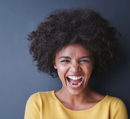 Laughing, black woman and portrait in studio with happiness, comedy or freedom in mockup space. Happy, face and African lady smile, emoji or crazy reaction to joke or humor on grey background