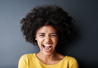 Laughing, black woman and funny portrait in studio with happiness, freedom or wellness in mockup space. Happy, face and African person with smile, emoji and crazy reaction on grey background - obrazy, fototapety, plakaty