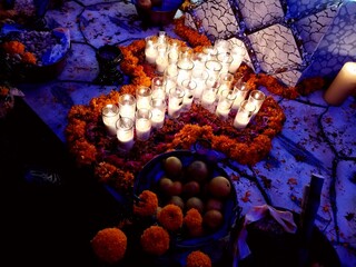 cross in the night candle and rose day of the dead altar in México day of the dead altar in...