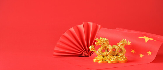 Golden figurine of dragon, paper fan and flag of China on red background with space for text