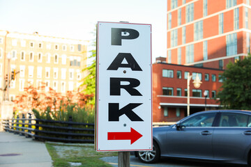 parking sign stands against a backdrop of urban life, a symbol of order and regulation in the bustling cityscape