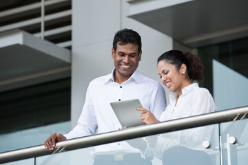 Indian Business people looking at a digital tablet.