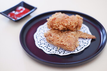 Crispy fried chicken on a plate with sauce, stock photo