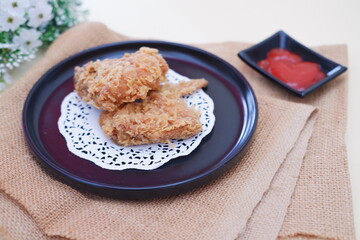 Crispy fried chicken on a plate with sauce, stock photo