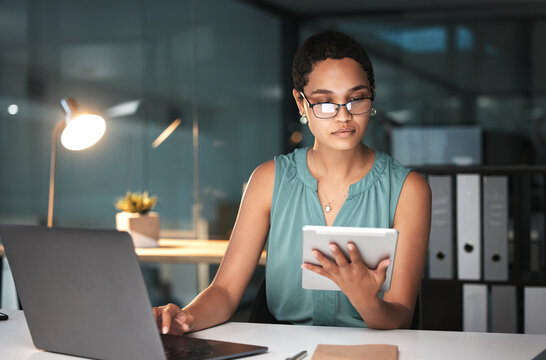 Tablet, laptop and business woman reading finance portfolio feedback, stock market database or African ecommerce. Forex investment budget, data analysis or night trader trading NFT, bitcoin or crypto