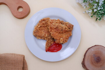 Crispy fried chicken on a plate with sauce, stock photo