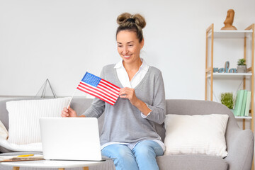 Mature woman with laptop studying English online at home - obrazy, fototapety, plakaty
