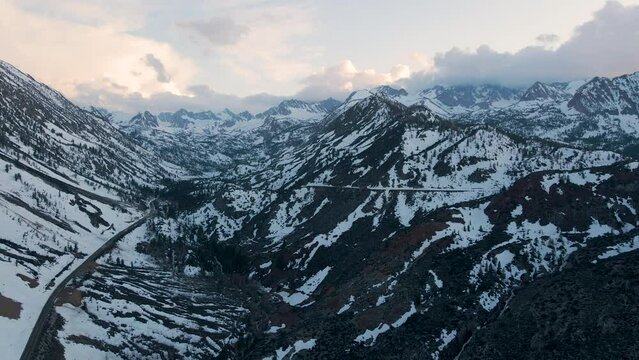 Cinematic aerial shot of snow covered Sierra Nevada mountains in California, USA
