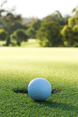A golf ball and hole