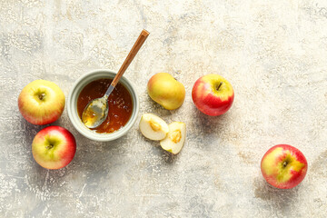 Bowl of sweet apple jam on grunge background