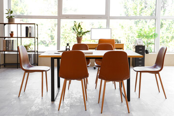 Interior of modern office with table and window