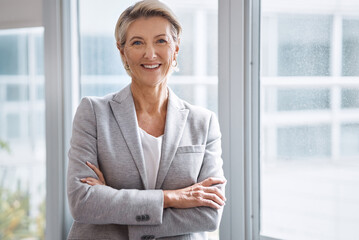 Business woman, portrait or arms crossed by window in corporate financial, investment company or insurance office. Smile, happy or confident mature ceo in about us with success mindset for management - obrazy, fototapety, plakaty