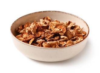 Bowl with dried mushrooms on white background